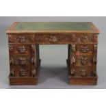 A VICTORIAN CARVED OAK PEDESTAL DESK inset gilt tooled green leather, fitted with an arrangement