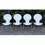 A set of four contemporary white-finish plywood & silvered metal stacking chairs of Arne Jacobsen st