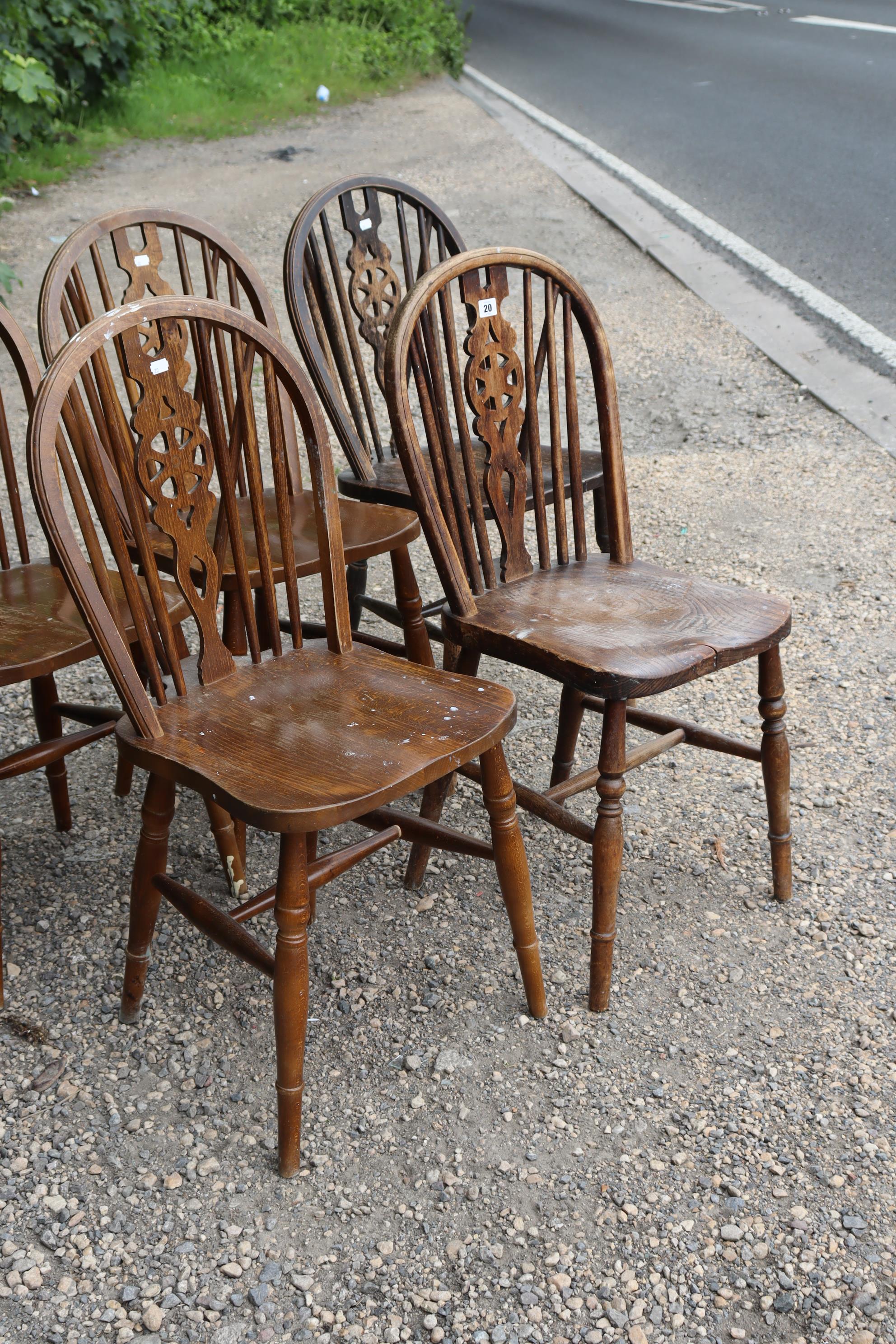 A set of six wheel-back dining chairs with hard seats, & on turned legs with spindle stretchers. - Image 3 of 6