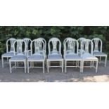 A SET OF TWELVE WHITE-PAINTED HEPPLEWHITE-STYLE DINING CHAIRS, including a pair of carvers, with