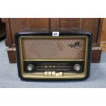 A Bush valve radio in a brown Bakelite case (Type VHF 61); & a Stanton laboratory balance (model