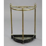 A Victorian brass demi-lune umbrella stand, with cast-iron drip-pan, 17” wide x 24½” high.