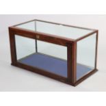 An early 20th century beech-frame table-top display cabinet enclosed by a fall-front door to the