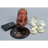 A terracotta-finish composition female-head wall plaque, 12” x 7¾”; together with a Japanese