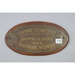 A painted metal oval plaque “RICHARD DUNSTON LTD SHIPBUILDER’S 1948 THORNE YORKS” mounted on a
