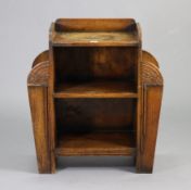 A mid-20th century oak small standing open bookcase/umbrella stand in the Art Deco style with carved