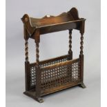 A 1930s mahogany floor-standing booktrough/magazine rack with barley-twist supports & having two