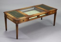 A reproduction mahogany display-top low coffee table enclosed by a glazed lift-top to centre flanked