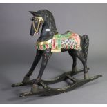 An Scandinavian black & multi-coloured floral painted wooden child’s rocking horse (slight faults),