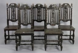 A set of five Carolean-style oak hall chairs, each with pierced & carved splat back, hard seat, & on