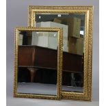 A large gilt frame rectangular wall mirror with a pierced scroll border & inset bevelled plate, 42½”