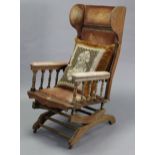 An early 20th century American beech-frame wing back rocking chair upholstered crimson velour, & a
