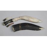 An Indian kukri with black leather sheath.