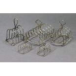 A pair of Edwardian small silver four-division toast racks, 2¾” wide, Chester 1909 by Haseler