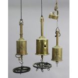 Four vintage brass spit-roasting jacks.