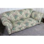 A late 19th/early 20th century three-seater drop-end settee with rounded back, scroll-arms &