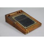 A 19th century brass-bound mahogany writing slope with a fitted interior, 13¾” wide.