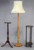 A beech standard lamp with a fluted & vase-turned centre column & on circular base, together with