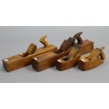 Four vintage wood carpenter’s block planes.