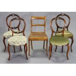 A set of four 19th century carved walnut balloon-back occasional chairs each with a padded seat, &