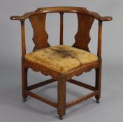 A Georgian mahogany corner elbow chair with shaped & open splat-back on turned supports, tan leather