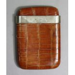 A George V crocodile skin cigar case with a silver mount, 6¾” x 4¾” London 1910.