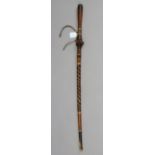 A West African leather-covered wooden walking cane, 35” tall.