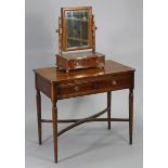 A reproduction mahogany side table fitted with a brushing slide above two short drawers, on