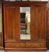 A Victorian mahogany wardrobe with a moulded cornice, enclosed by a bevelled mirror door to centre