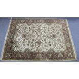 An Indian small carpet of cream ground & with all-over repeating multi-coloured geometric design