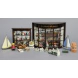 A reproduction mahogany bow-front miniature shop-window display, 13½” wide x 9¾” high; & various