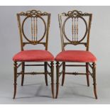 A pair of Gillow & Co Victorian walnut occasional chairs, each with carved & painted floral