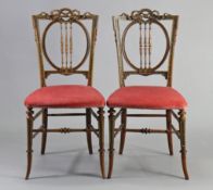 A pair of Gillow & Co Victorian walnut occasional chairs, each with carved & painted floral