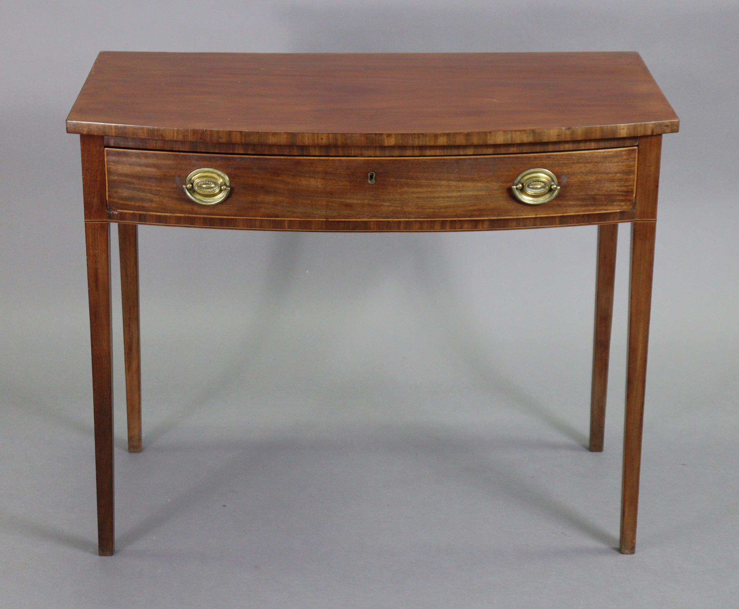 A 19th century mahogany bow-front side table with plain rectangular top, fitted single frieze drawer