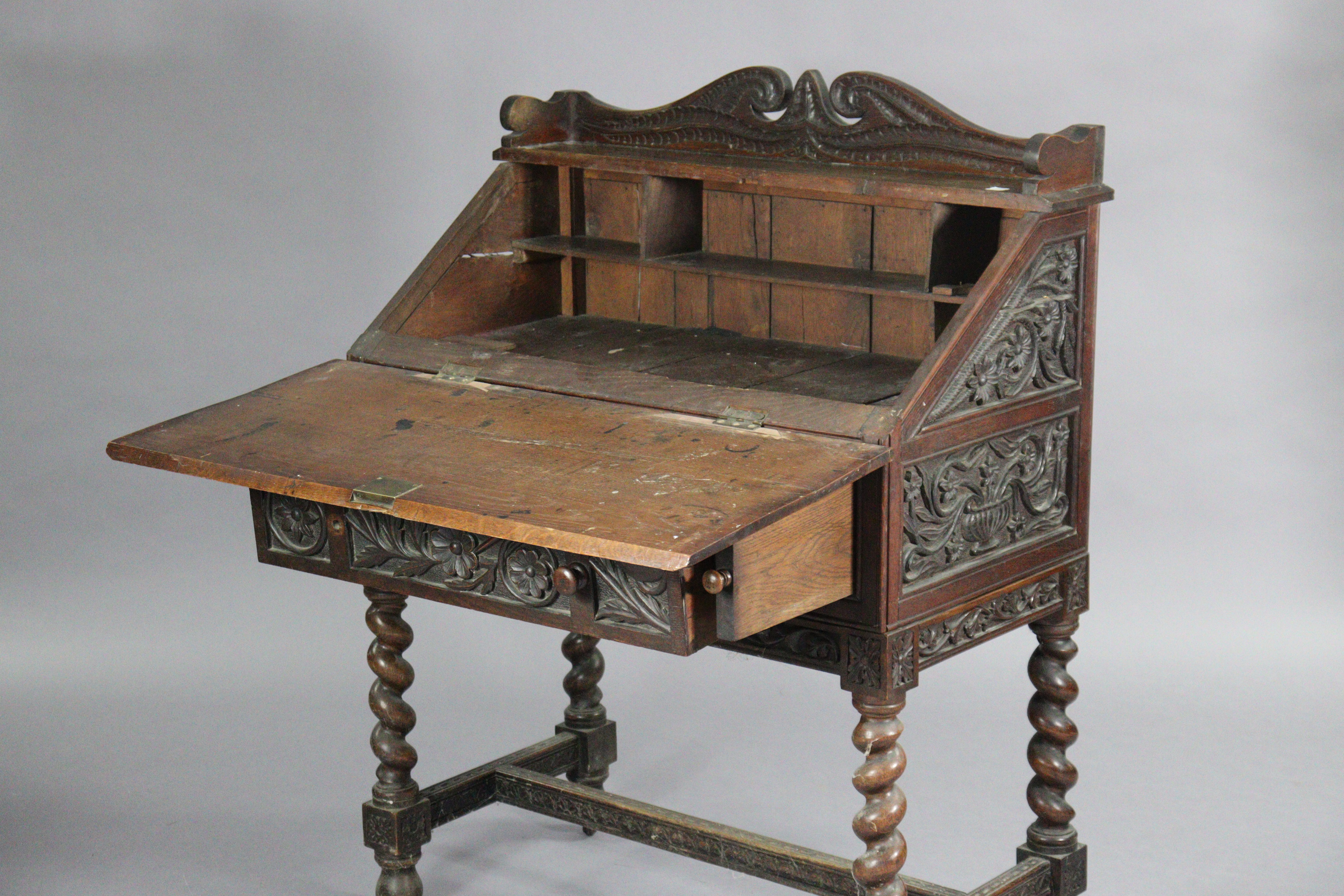 An early 20th century carved oak bureau, with shaped tray-top above a fitted interior enclosed by - Image 2 of 5