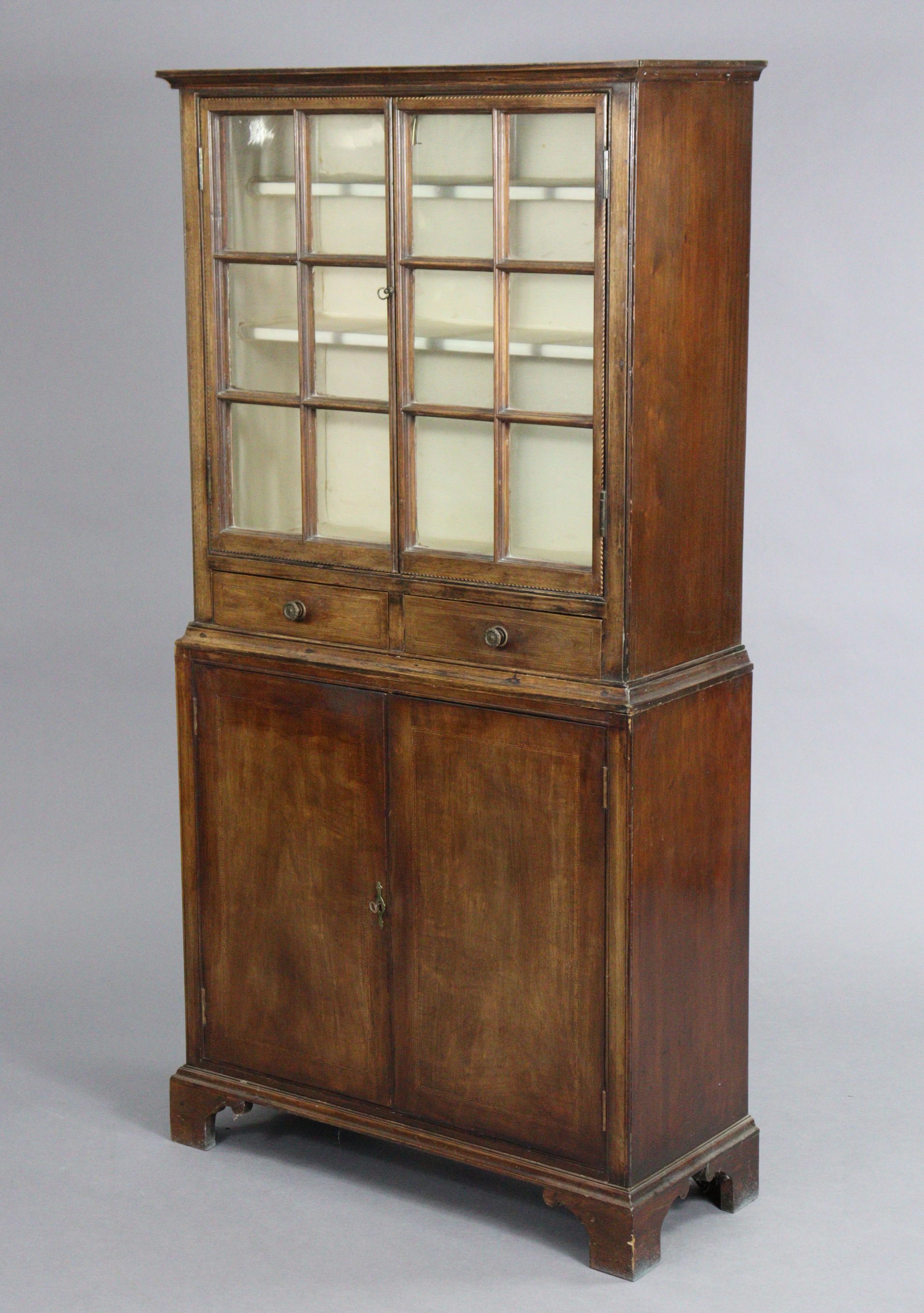 A 19th century inlaid mahogany display cabinet, fitted two shelves to the top, enclosed by pair of