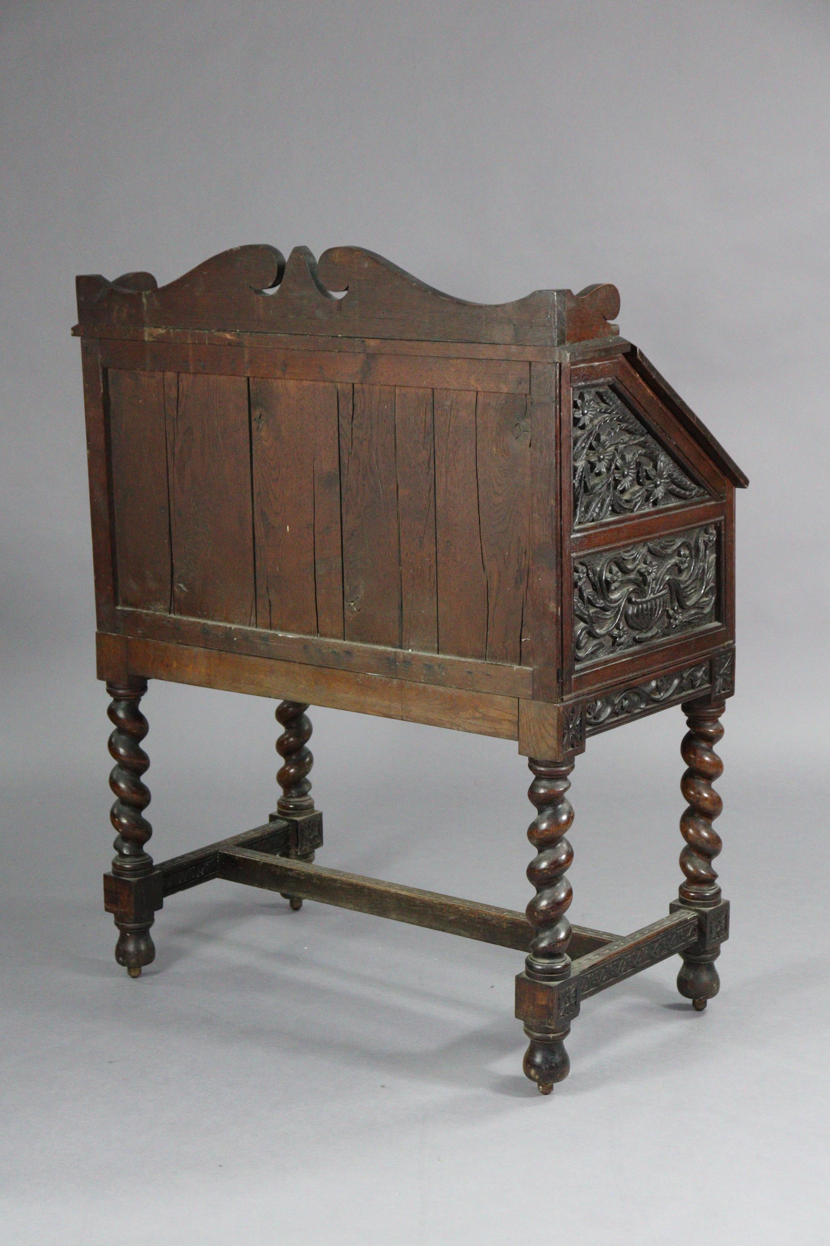 An early 20th century carved oak bureau, with shaped tray-top above a fitted interior enclosed by - Image 4 of 5