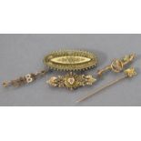 A 15ct. gold Etruscan revival oval brooch, 1¾” wide (5.7 gm); a 9ct. “Baby” bar brooch & two other