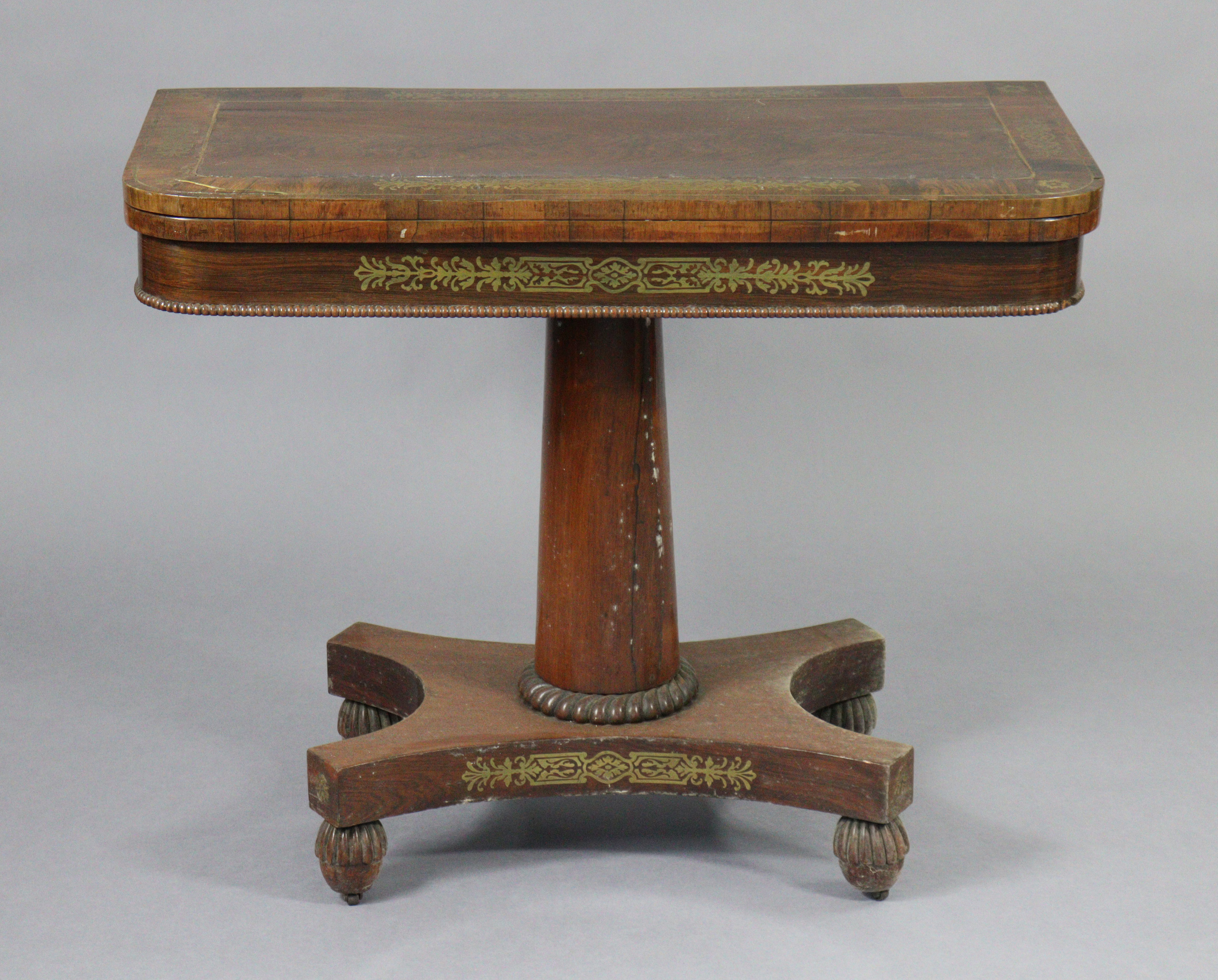 An early 19th century brass-inlaid card table, with rounded corners to the rectangular top, inset gr