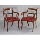 A pair of regency-style mahogany elbow chairs with brass inlay to the curved backs, having rope-twis