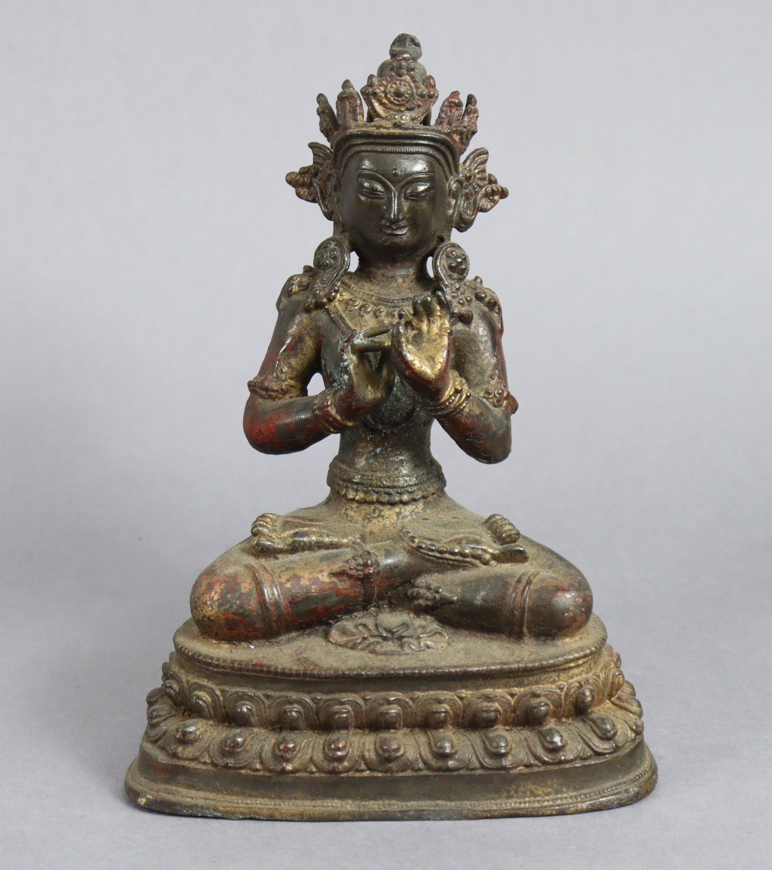 A Sino-Tibetan bronze model of a Boddhisattva, seated on double-lotus base, 9½” high.