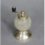A late Victorian cut glass spherical pepper mill with silver mounts & crank handle to top, 3½” high,
