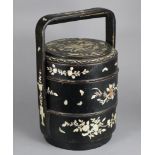 A late 19th/early 20th century Chinese lacquered picnic box of three stacking cylindrical tiers, the
