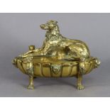 An Edwardian heavy cast brass oval inkwell, the removable cover in the form of a recumbent hound,