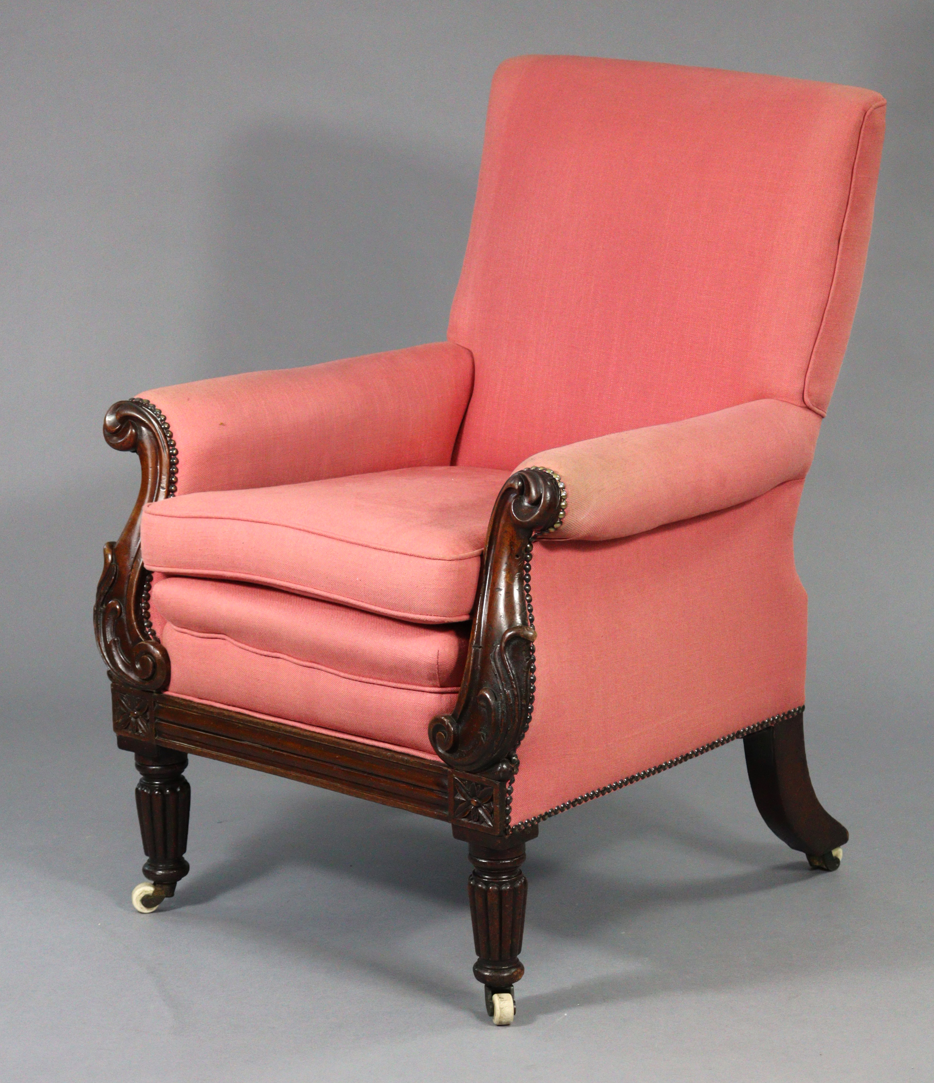 A William IV mahogany frame library armchair upholstered red fabric with loose cushions, carved