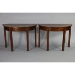 A Georgian mahogany D-end dining table with later supports for the central leaf, on reeded square