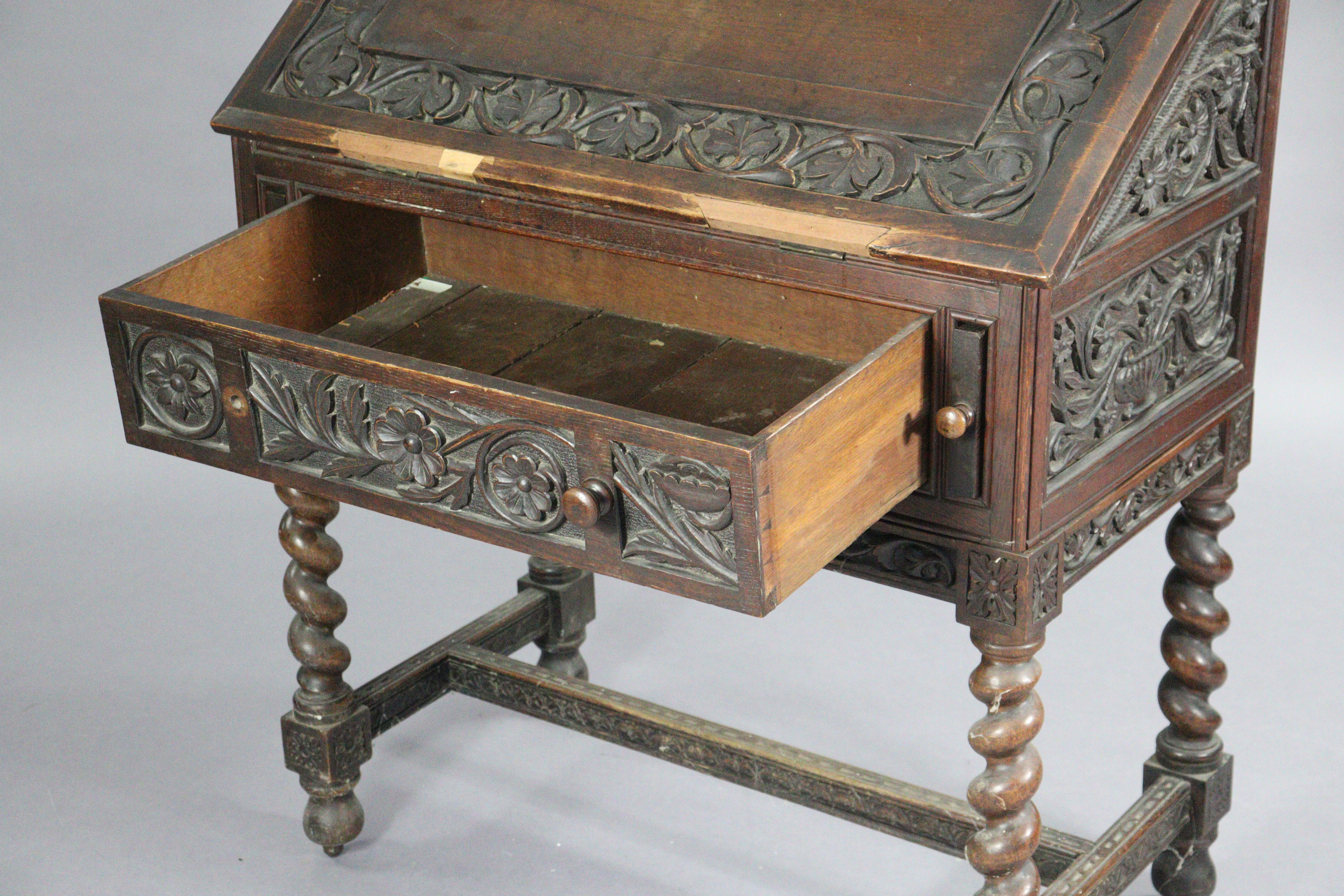 An early 20th century carved oak bureau, with shaped tray-top above a fitted interior enclosed by - Image 3 of 5