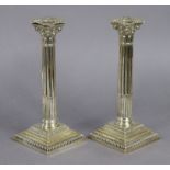 A pair of late Victorian silver candlesticks, the round stop-fluted columns with composite capitals,