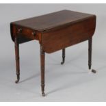 A Victorian mahogany pembroke table with rounded corners to the drop leaves, fitted single end