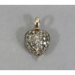 A yellow metal small heart-shaped pendant, pavé-set with rose diamonds. (1.4 gm).